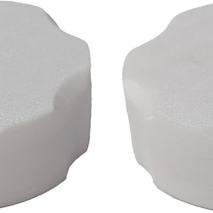 May include: Two white plastic knobs with a six-sided star shape. The knobs have a smooth, slightly textured surface.