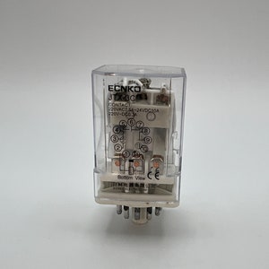 May include: A clear plastic enclosure with a white electrical relay inside. The relay has the text "ECNKO JTX-3C" and "CONTACT 220VAC7.5A-24VDC10A 220V-DCD 3A" printed on it. The bottom of the enclosure has the text "Bottom View CE 日科电器有限公司 ECNKO ELECTRICLIMI LTD" printed on it.