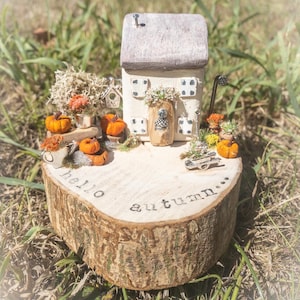 Driftwood scene art. Hello autumn miniature house on log slice.