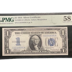 Peut inclure: Un certificat d'argent de 1 $ de 1934, classé Choice About Uncirculated (58) par PMG. Le certificat présente un portrait de George Washington et le texte "The United States of America" en encre bleue. Le numéro de série est C55548205A.