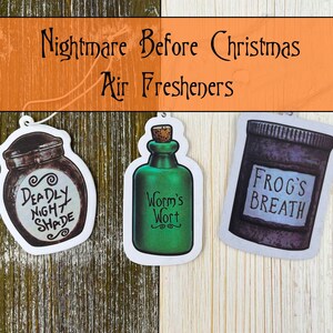 May include: Three air fresheners with a "Nightmare Before Christmas" theme. One is a jar labeled "Deadly Night Shade", another a green bottle with "Worm's Wort", and the last a jar with "Frog's Breath". The background is a mix of wood textures.