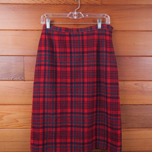 May include: A red and black tartan skirt with a straight cut and a simple design.