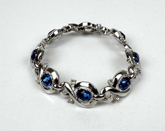 Vintage women’s silver tennis bracelet with blue stones