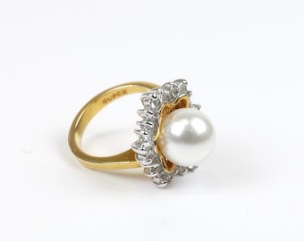 Vintage women’s pearl ring with gold band and CZ stone snowflake design