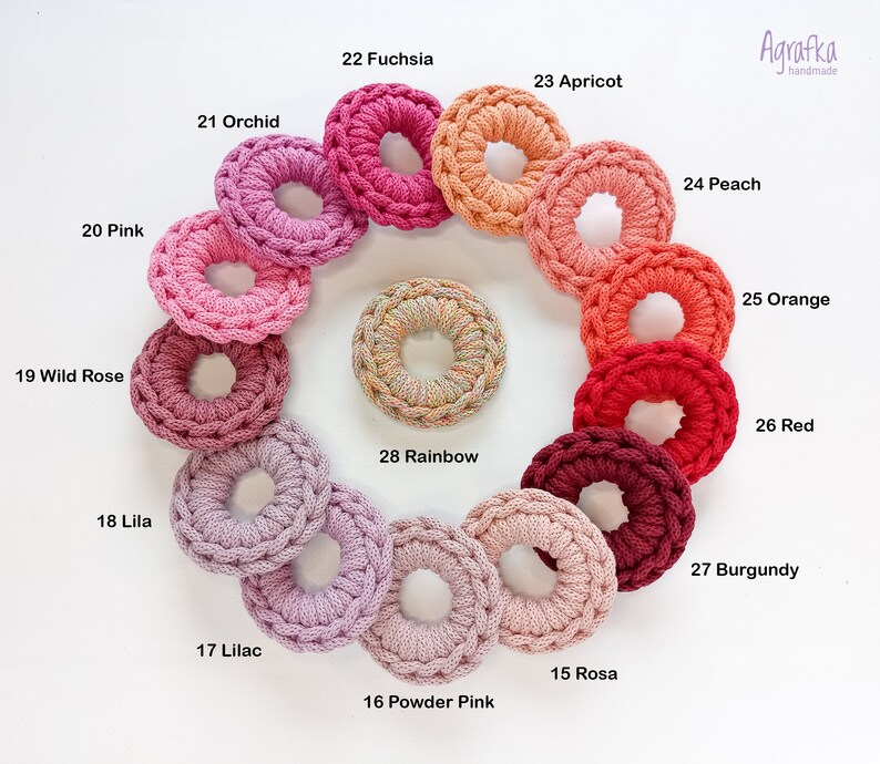 May include: Agrafka handmade crochet rings in a variety of colors, including pink, red, orange, yellow, and purple. The rings are arranged in a circle, with the colors transitioning from light to dark.