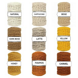 May include: Nine spools of cotton rope in various colors, including natural, beige, dark beige, yellow, honey, pumpkin, latte, cappuccino, and caramel. Each spool has a label with the color name.