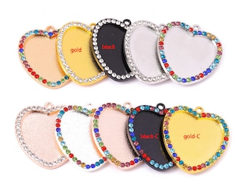 May include: Assortment of heart-shaped pendant trays with a rhinestone border. The trays are available in gold, silver, and black finishes. The trays are perfect for creating custom jewellery.