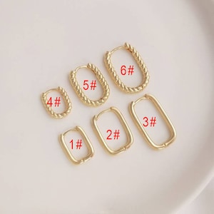 May include: Six pairs of gold hoop earrings in different sizes. The earrings are numbered 1 through 6.