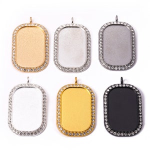 May include: Six rectangular pendant charms with a rhinestone border. The charms are available in gold, silver, black, and white.