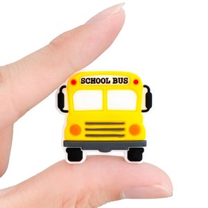 May include: Yellow school bus toy with black wheels and the words "SCHOOL BUS" printed on the front.