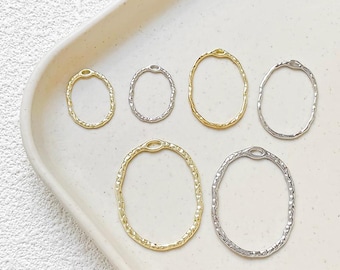 May include: Five gold and silver oval-shaped jump rings of varying sizes. The jump rings are textured and have a hammered finish.
