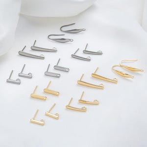 May include: A collection of gold and silver earring findings, including hooks, posts, and loops. These findings are perfect for creating custom earrings.
