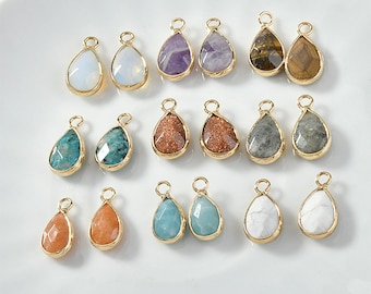 May include: Assortment of 18 gold-tone teardrop-shaped pendants with various gemstone inlays. The gemstones include amethyst, tiger's eye, turquoise, and more.