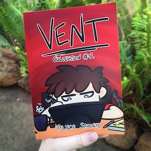 May include: A red comic book cover with the title "VENT COLLECTION #1" in black text. The cover features a cartoon illustration of a person sitting at a desk with a laptop, looking frustrated.