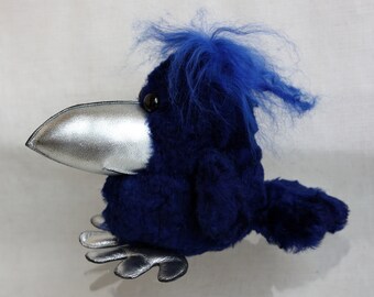 A blue stuffed crow with a silver beak and paws, Furry crow punk, interior toy