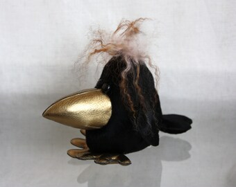 Black fur crow with golden beak and paws, interior toy