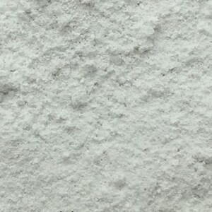 May include: A close-up view of a white powder. The powder is fine and has a slightly grainy texture.