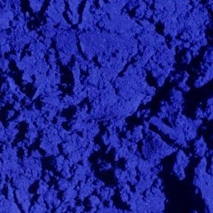May include: Close-up of a blue powder with a grainy texture.