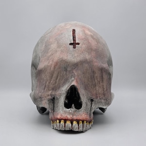 Blinded by darkness . Realistic Plaster of Paris life size human skull replica.