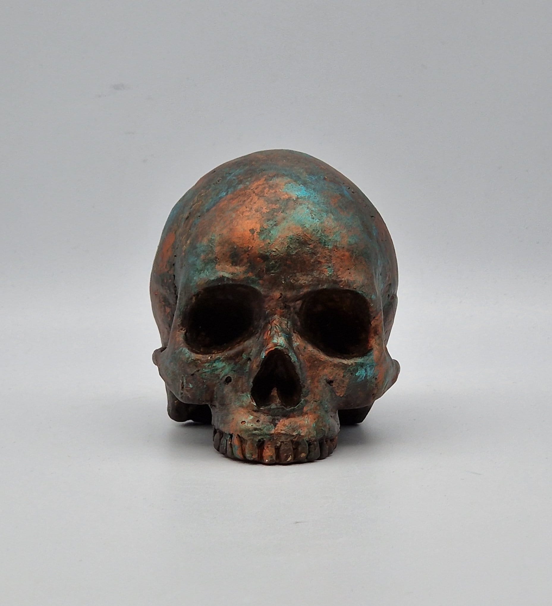 Solid copper patina mini human Skull ornament. Small replica plaster of Paris human skull.