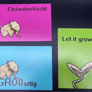 Conjunto de cartão postal de origami com cor marcante e texto correspondente, elefante e planta dobrados nas páginas do livro