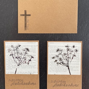 Trauerkarte Naturdruck Schwarze Blume auf Buchseite und Kraftpapier Postkarte bedruckt mit ‚Aufrichtige Anteilnahme‘