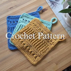 May include: Three handmade crochet potholders in blue, teal, and mustard yellow. Each square potholder has a loop for hanging and a textured design. The text "Crochet Pattern" is overlaid on the image.