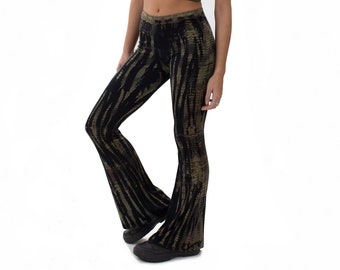 May include: Olive green crop top and black and olive green tie-dye bell-bottom pants. The pants have a flared leg design and a unique pattern. The outfit is shown against a white background.