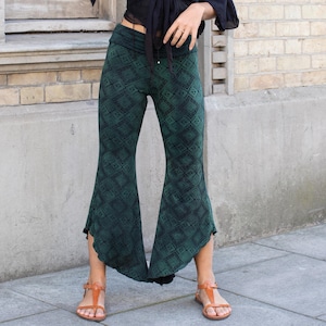 May include: Green and black patterned bell bottom pants with a wide leg.