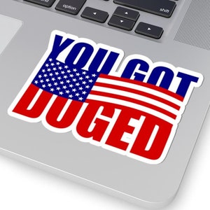 May include: A white sticker with a red, white, and blue American flag and the text "YOU GOT DUGED" in blue and red letters.