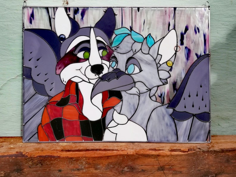 May include: Stained glass panel featuring two anthropomorphic characters. One is a raccoon in a red and black plaid shirt, the other is a bird-like creature. The artwork uses shades of purple, gray, red, and white, with green and blue accents.