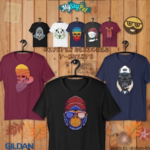 May include: A collection of t-shirts with various designs featuring a skull with a beard, a panda, a skull with a crown, a zebra, a gorilla with a hat, and a gorilla with sunglasses and an American flag bandana. The text "Hipster Designed T-Shirts" is displayed above the shirts. The text "Gildan" is displayed at the bottom left of the image. The text "linktr.ee/skyboy46" is displayed at the bottom right of the image.