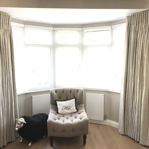 Extra wide windows with double pleat curtains in Zoffany Water