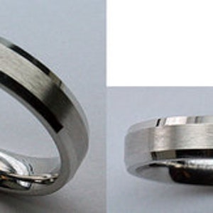 May include: A silver wedding band with a brushed finish and a beveled edge.