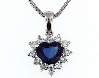 May include: A silver necklace with a heart-shaped pendant featuring a blue sapphire surrounded by smaller diamonds.