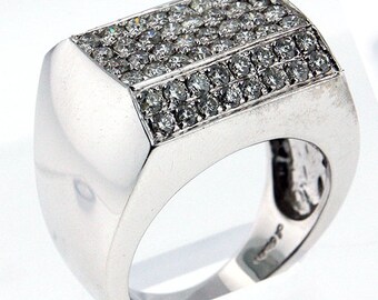 May include: A silver men's ring with a rectangular top set with small diamonds. The ring is made of metal and has a polished finish.
