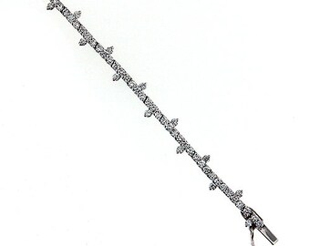 May include: A silver tennis bracelet with a row of small diamonds set in a delicate design.