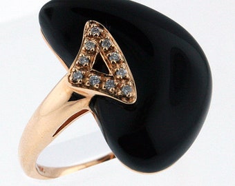 May include: A gold ring with a black heart-shaped stone and a diamond triangle design.