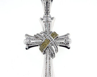 May include: A silver cross pendant with a diamond-encrusted design. The cross features a yellow diamond ribbon in the center.