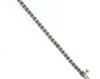 May include: A rose gold tennis bracelet with a row of small, clear diamonds.