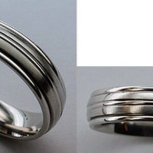 May include: A silver wedding band with a grooved design.