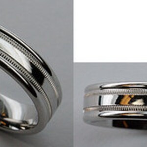 May include: A silver wedding band with a grooved design.