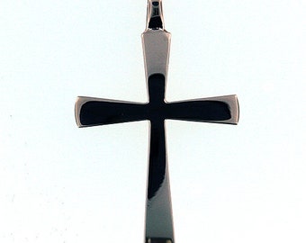 May include: A silver-toned cross pendant with a dark, reflective center, suspended from a delicate gold chain. The cross features a polished finish and rounded edges, creating a sleek and modern aesthetic. The pendant hangs against a plain white background.