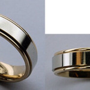 May include: A two-tone wedding band with a brushed silver finish and a gold band around the edge.