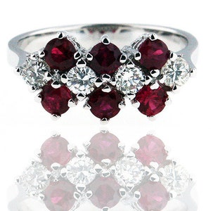 May include: A white gold ring with a row of alternating ruby and diamond stones. The ring features a total of 10 stones, with 5 rubies and 5 diamonds.