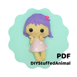 May include: A handmade felt doll with a yellow face, purple hair, and a pink dress with white polka dots. The doll has a small pink flower in its hair and is set against a light green scalloped background. The text "PDF DIYStuffedAnimal" is displayed.