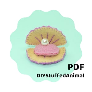 May include: A felt clam shell with a pearl inside. The clam shell is yellow with purple stitching and the pearl is white. The clam shell is sitting on a light blue background. DIYStuffedAnimal PDF.