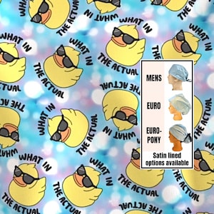 May include: A light blue fabric with a repeating pattern of yellow ducks wearing sunglasses. The ducks are surrounded by the phrases "WHAT IN" and "THE ACTUAL". The image also shows examples of surgical caps.
