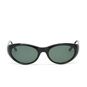 May include: Black oval sunglasses with dark green lenses.