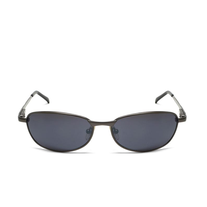 May include: Oval-shaped sunglasses with dark gray lenses and a thin, dark metal frame. The temples are also dark metal and attach to the lenses with a small hinge. The sunglasses are set against a white background.